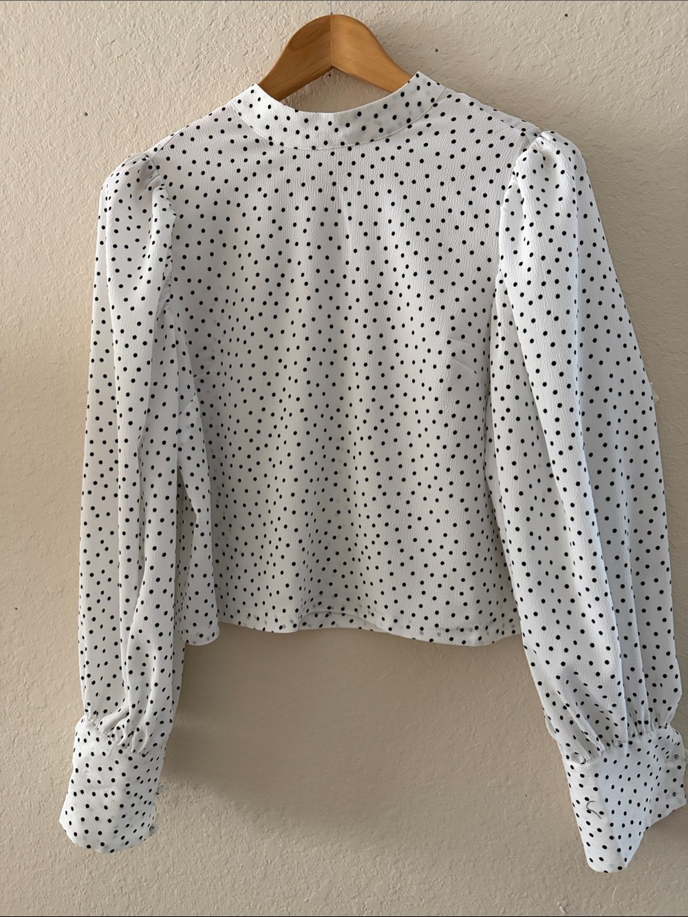 White waist length Blouse has black polka dots